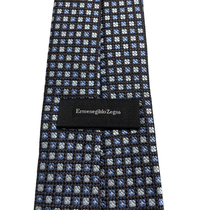 Ermenegildo Zegna blue silk tie with subtle sheen and logo detail.
