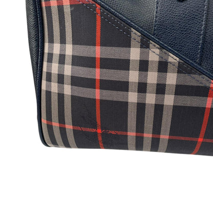 Burberry navy blue duffel bag featuring iconic Nova Check pattern and leather accents.