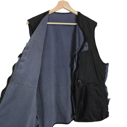 Stone Island navy blue reversible vest with green edge and logo patch detail.