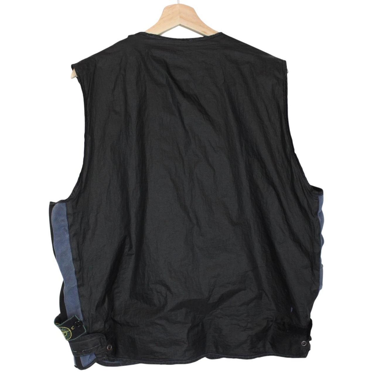 Stone Island navy blue reversible vest with green edge and logo patch detail.