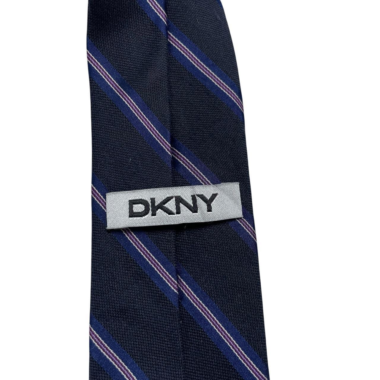 DKNY navy blue striped tie in silk/polyester blend with elegant sheen.