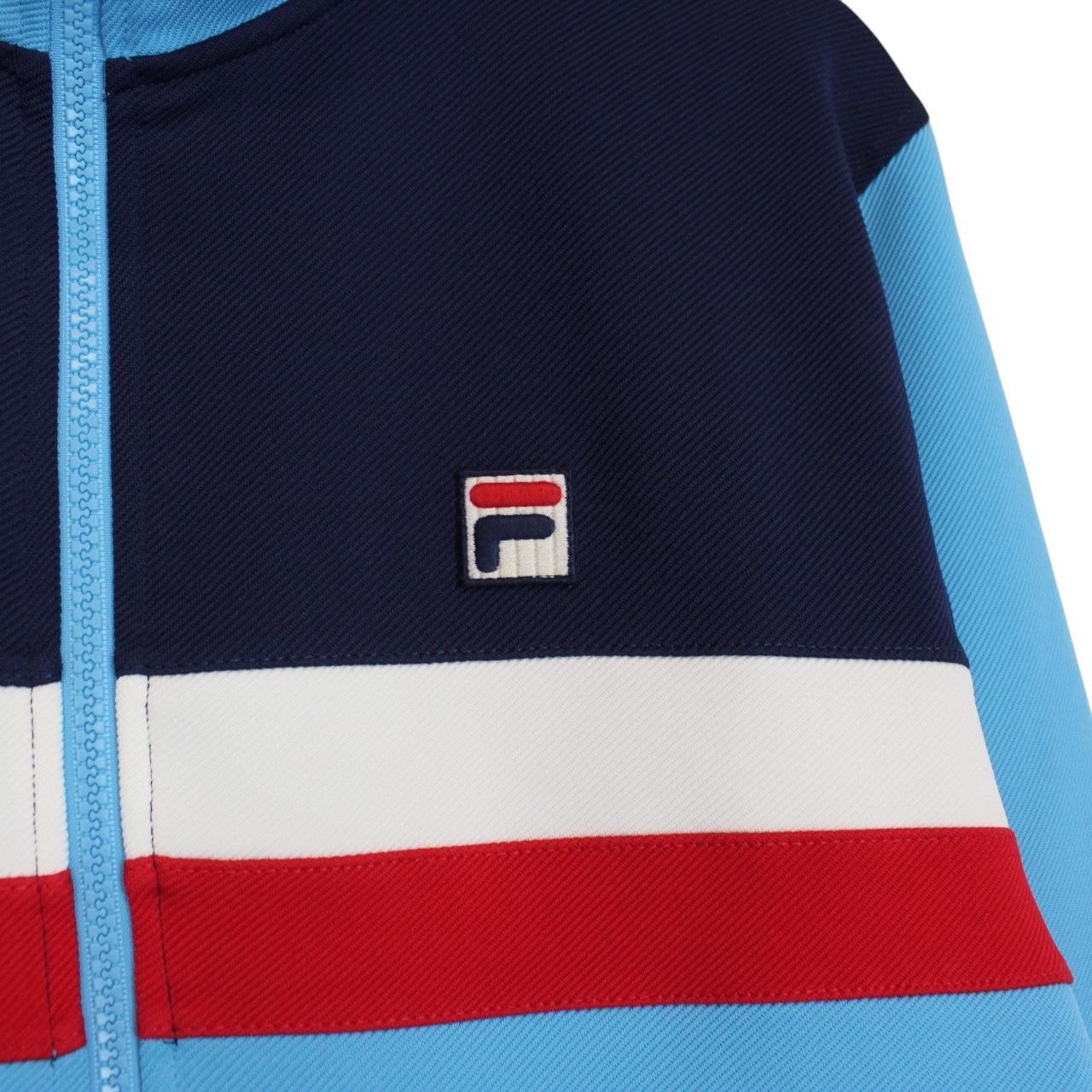 Fila blue track jacket with white stripes and embroidered logo on chest.