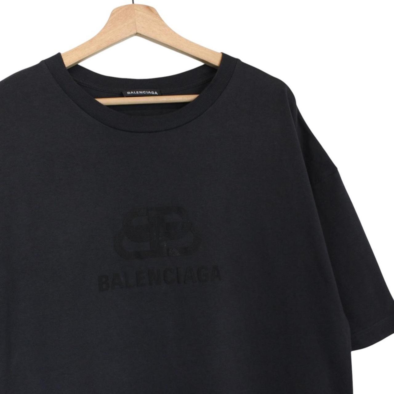 Balenciaga black oversized pocket t-shirt with bold logo print on front.