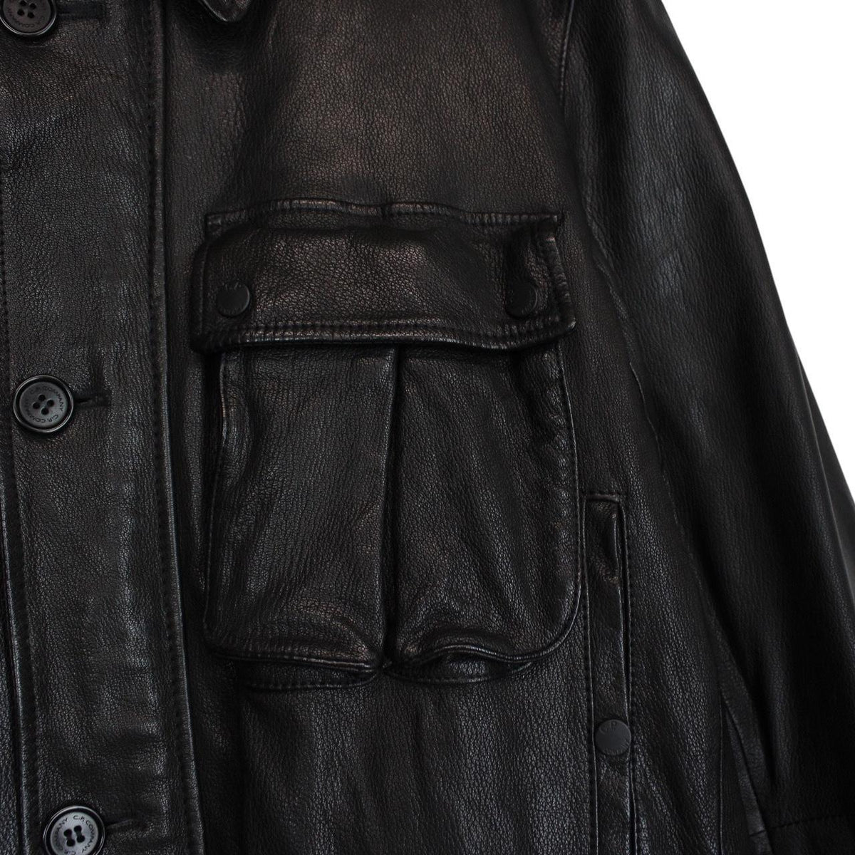 CP Company black leather jacket with multi pockets and logo detail.