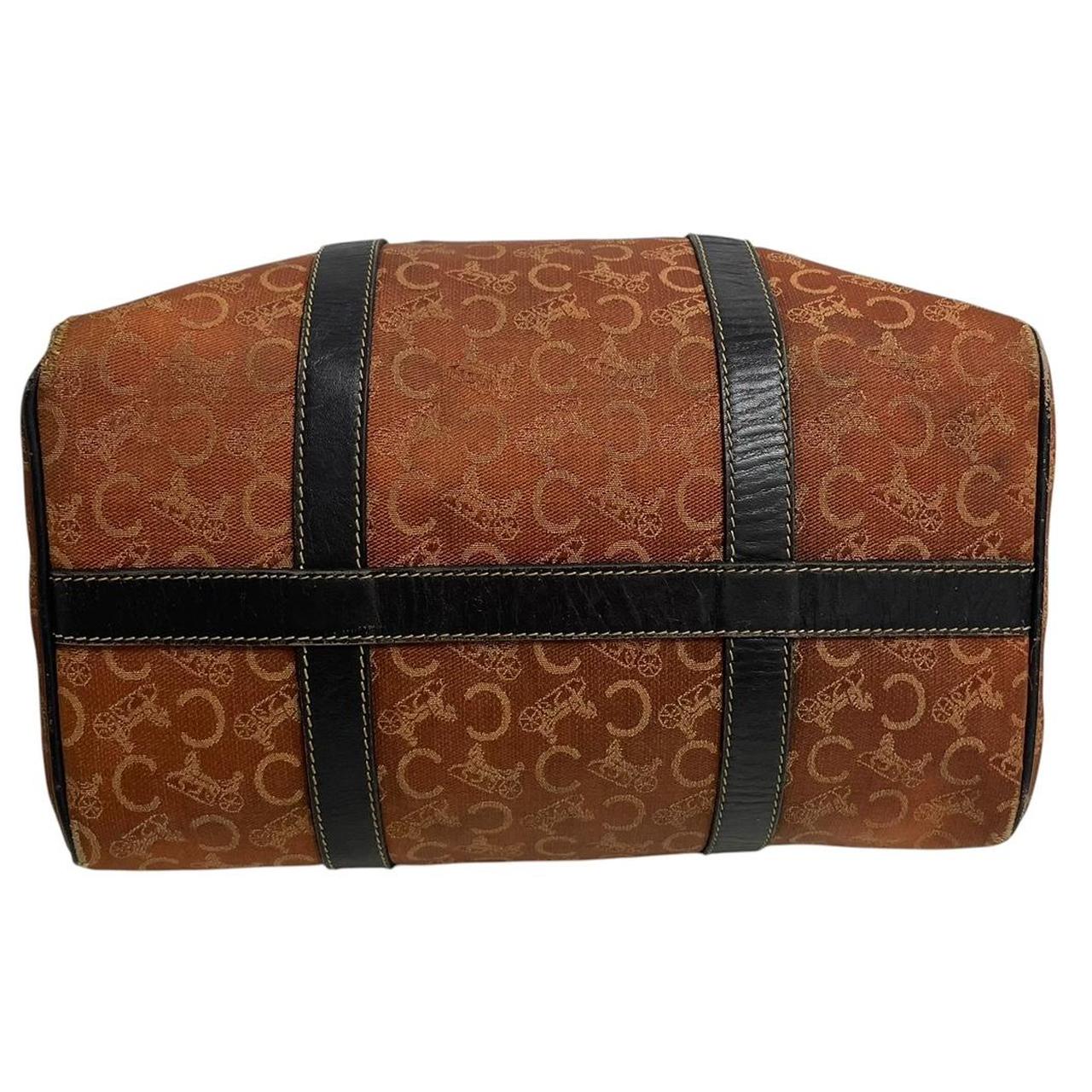 CELINE orange duffel bag with Macadam canvas and leather, visible wear and discolouration.