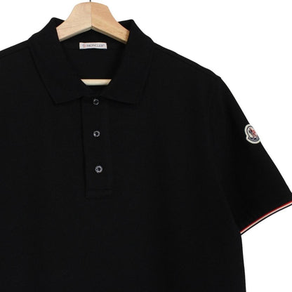 Moncler black short sleeve polo shirt with embroidered logo and cotton material.