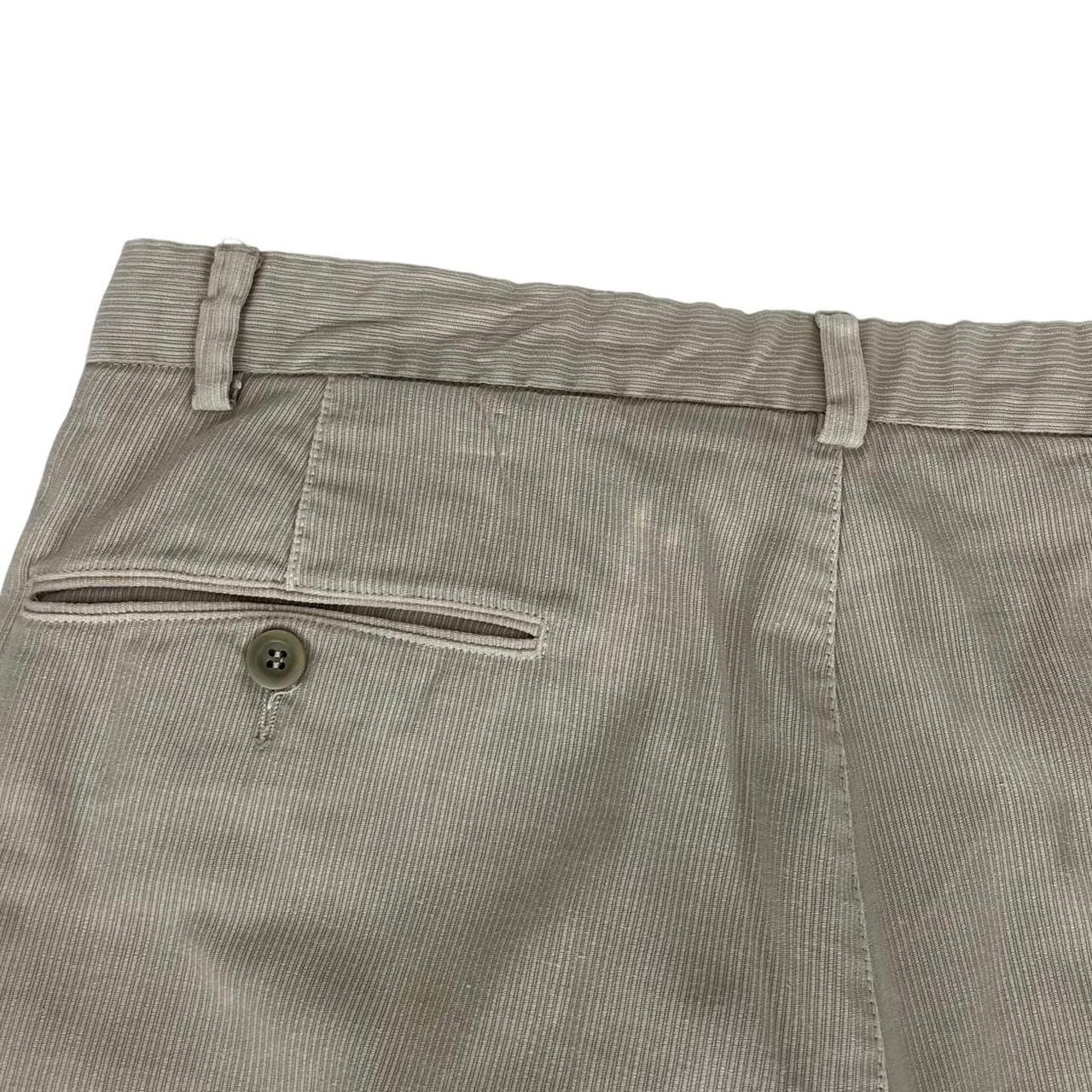 CP Company beige ribbed cotton trousers with faint stains and regular fit design.