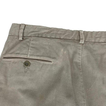 CP Company beige ribbed cotton trousers with faint stains and regular fit design.