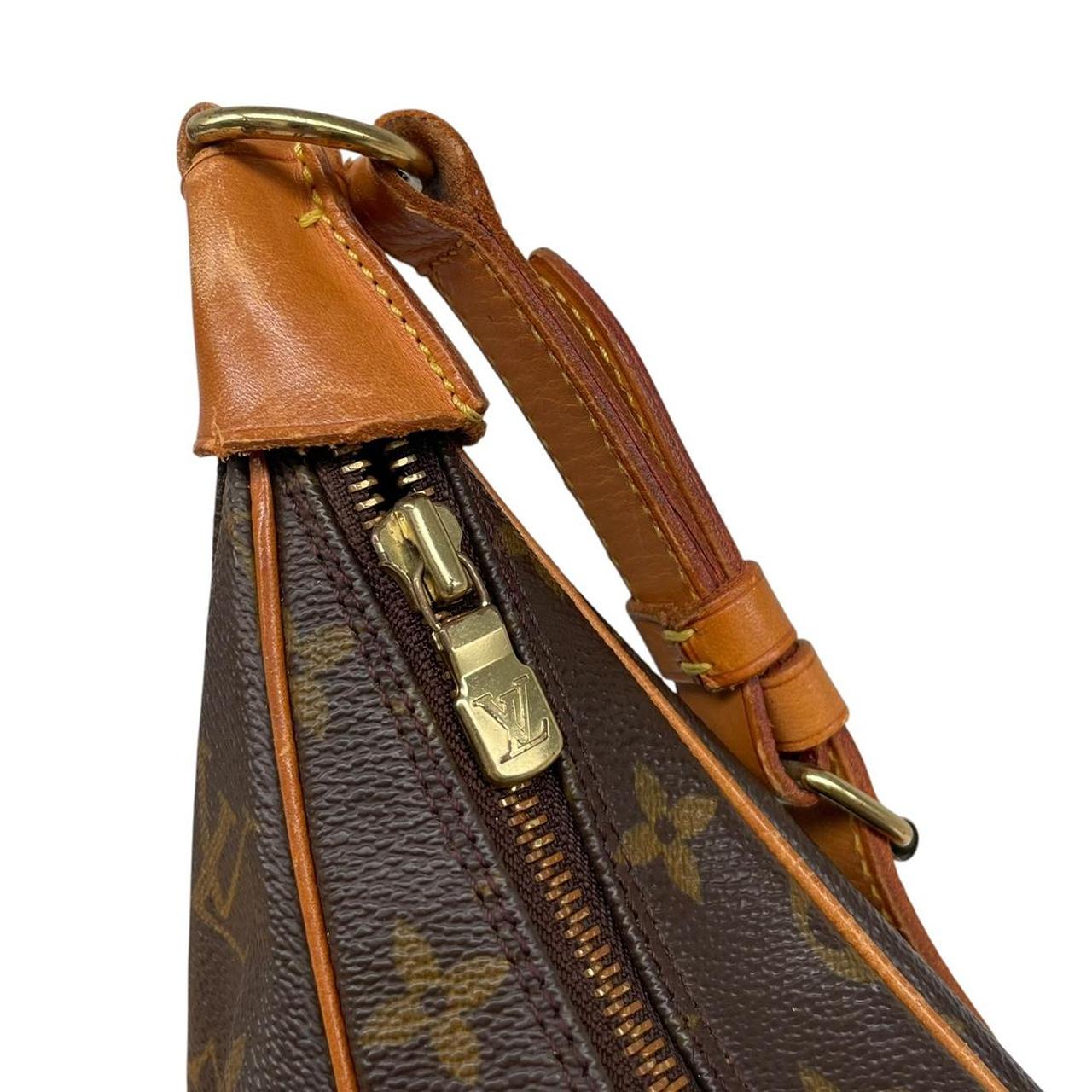 Louis Vuitton brown and tan monogram canvas duffel bag with leather accents and logo.