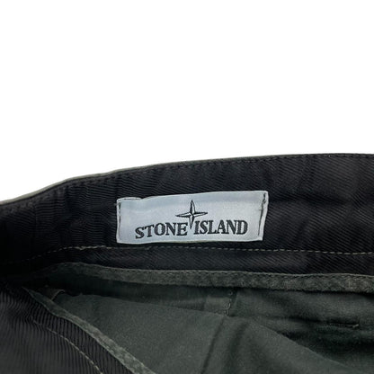 Stone Island green slim fit cotton trousers with logo patch and faded details.