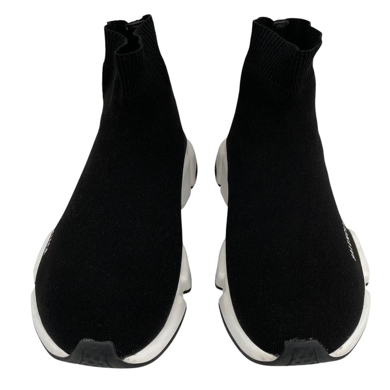 Balenciaga Speed 2 black and white trainers with logo detailing and cotton material.