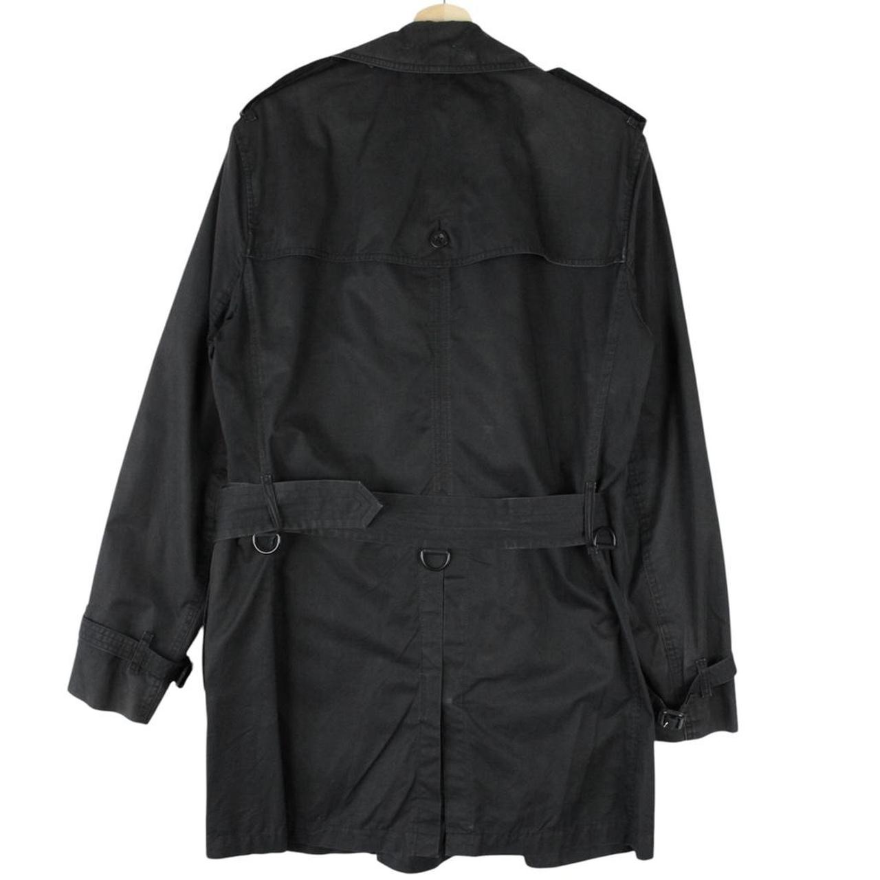 Burberry black trench coat featuring Nova Check pattern, double-breasted design, and belted waist.