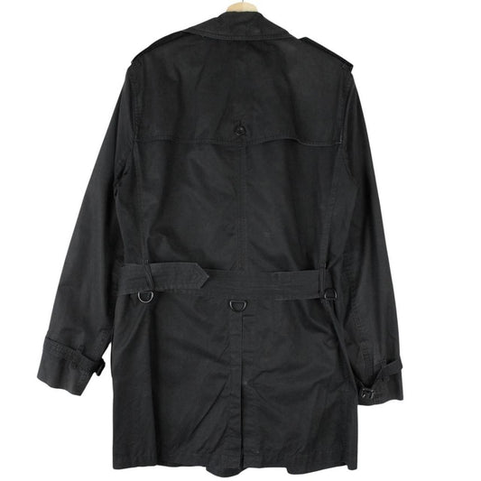 Burberry black trench coat featuring Nova Check pattern, double-breasted design, and belted waist.
