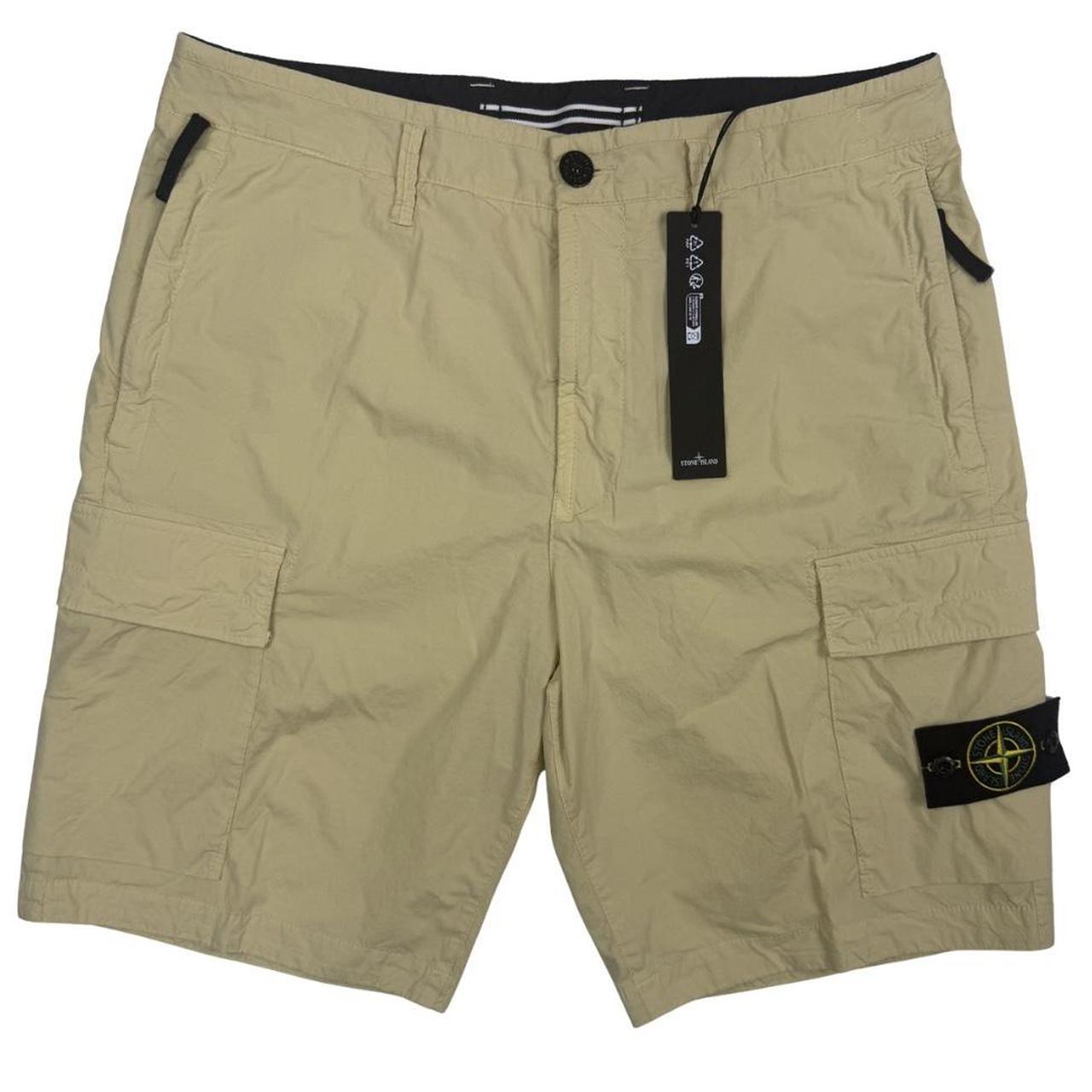 Stone Island beige cargo shorts with logo patch and multiple pockets in cotton material.