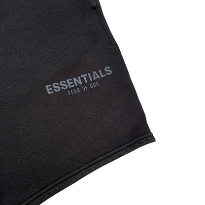 Essentials black jogger shorts cotton material with faded detailing and logo.