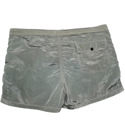 Stone Island green swim shorts with logo patch and nylon metal material.