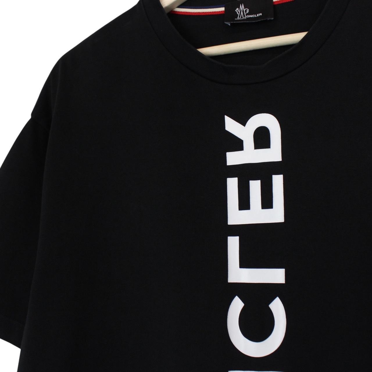 Moncler black and white short sleeve t-shirt with vertical logo design.