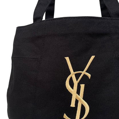 Yves Saint Laurent black duffel bag with gold embroidery and logo detail.