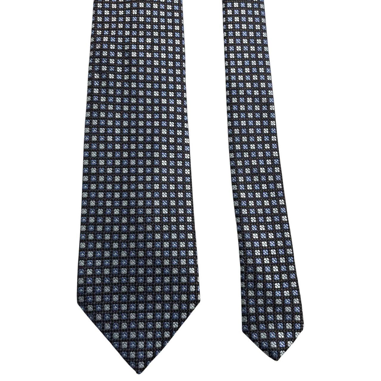 Ermenegildo Zegna blue silk tie with subtle sheen and logo detail.