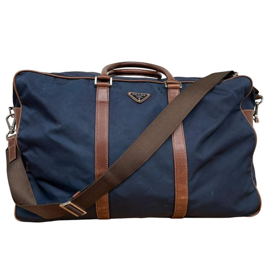 Prada navy blue and brown nylon duffel bag with signature logo and minimal wear.