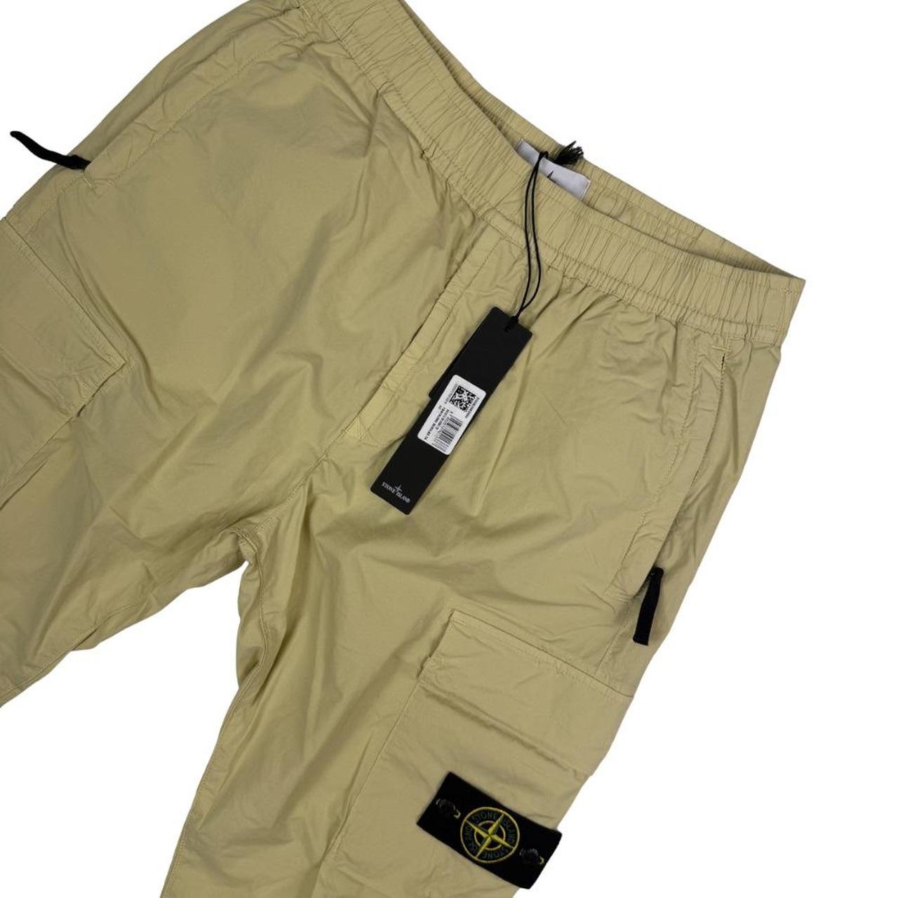 Stone Island beige cargo trousers with logo patch and stretch cotton material.