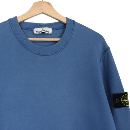 Stone Island blue cotton sweatshirt with embroidered logo and slight wear marks.