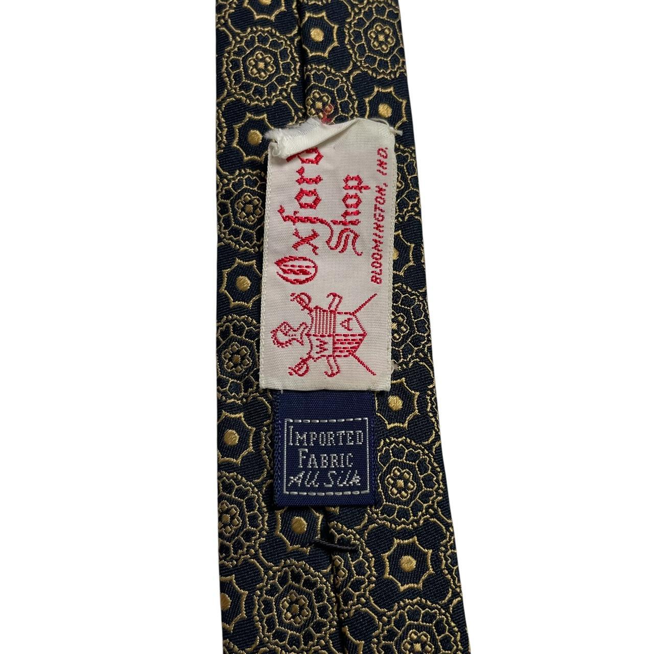 Polo Ralph Lauren black and gold silk tie with geometric print design.