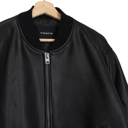 Coach black lamb leather bomber jacket with full zip and brand logo.