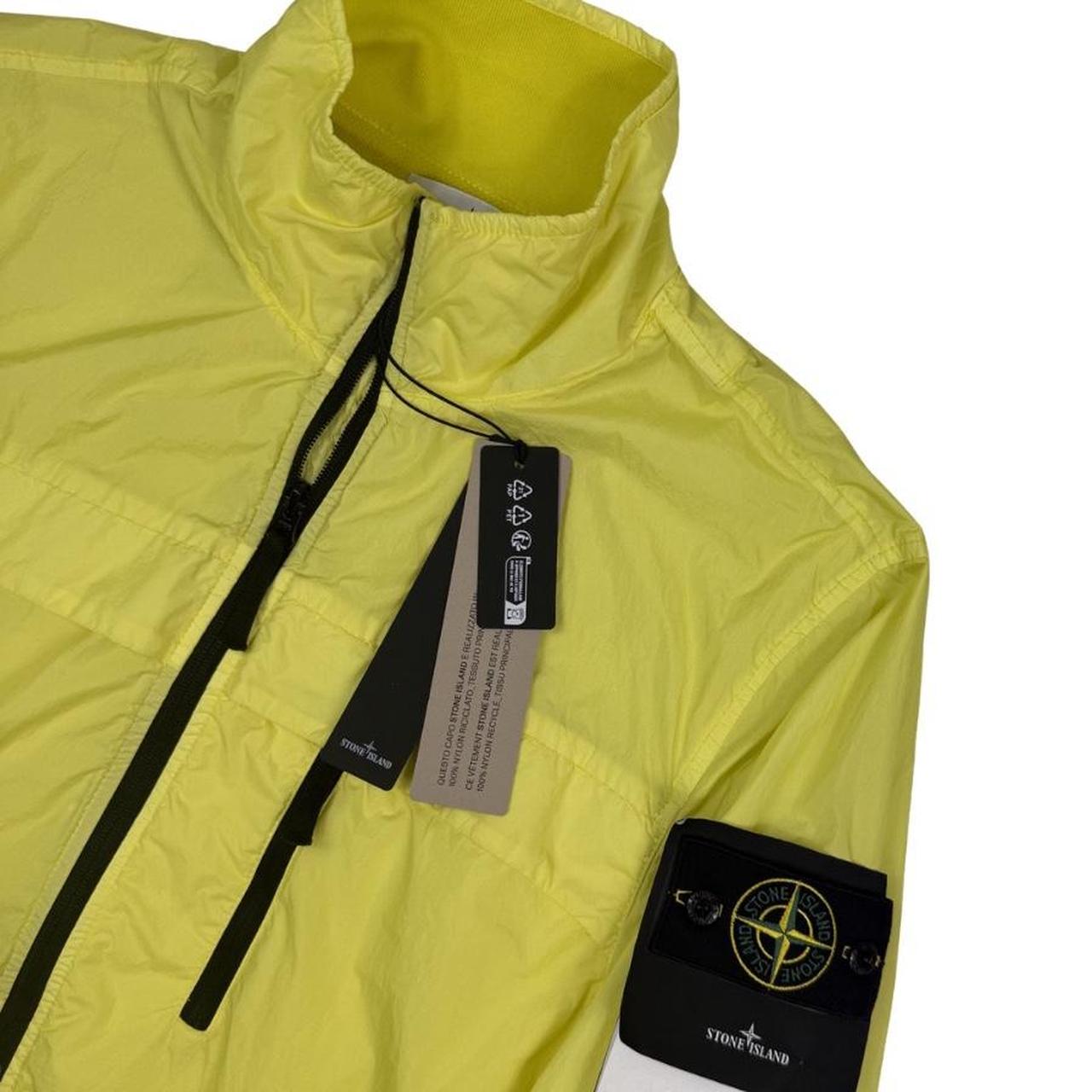 Stone Island yellow full zip jacket with crinkle texture and iconic compass logo.