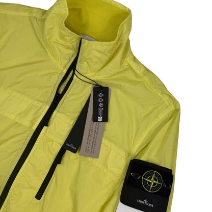 Stone Island yellow full zip jacket with crinkle texture and iconic compass logo.