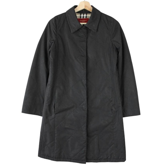 Burberry black trench coat featuring Nova Check pattern and quilted fabric.