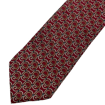 Gucci burgundy silk tie with vintage pattern and signature logo detail.