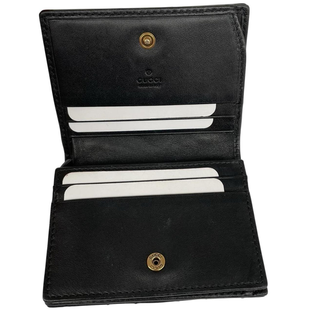 Gucci black calfskin wallet with matelassé pattern and GG logo detail.
