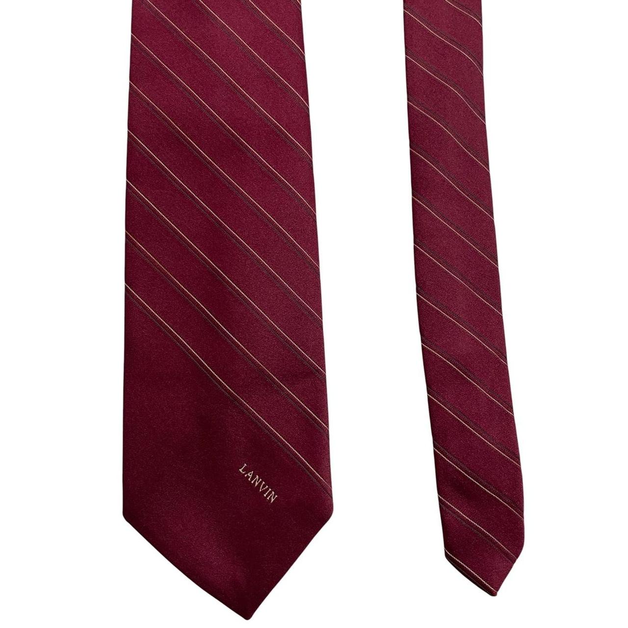 Lanvin burgundy silk tie with logo print and smooth texture.