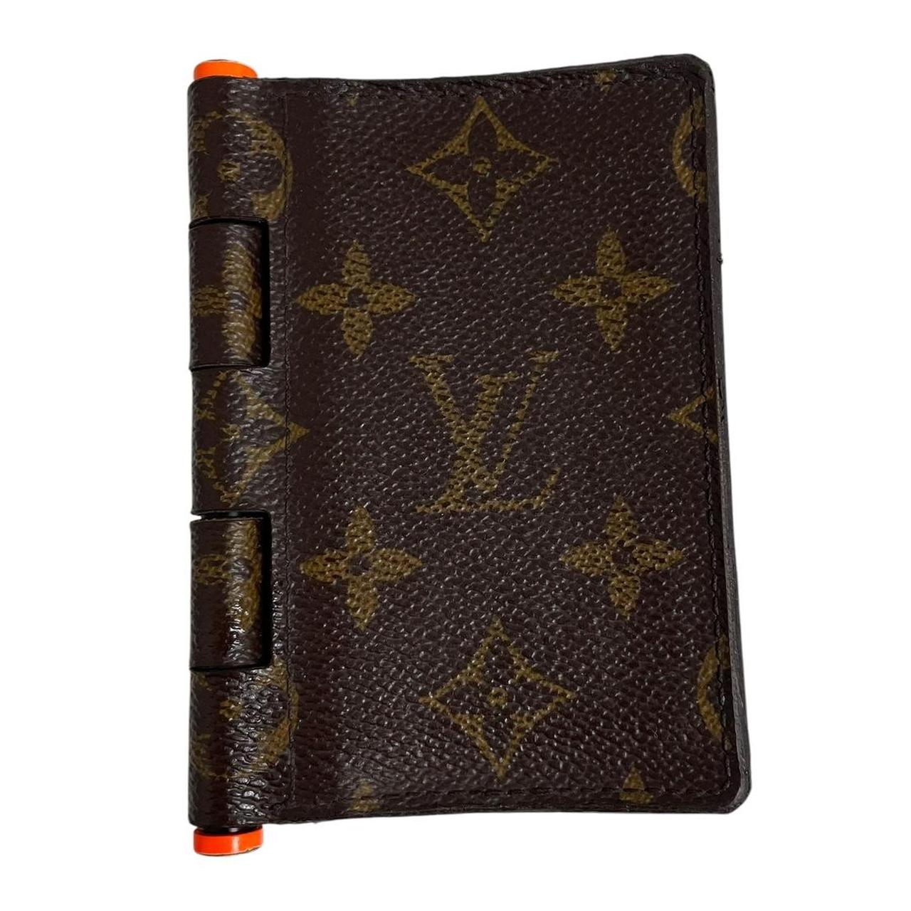 Louis Vuitton brown purse with orange metal hardware and iconic monogram pattern.