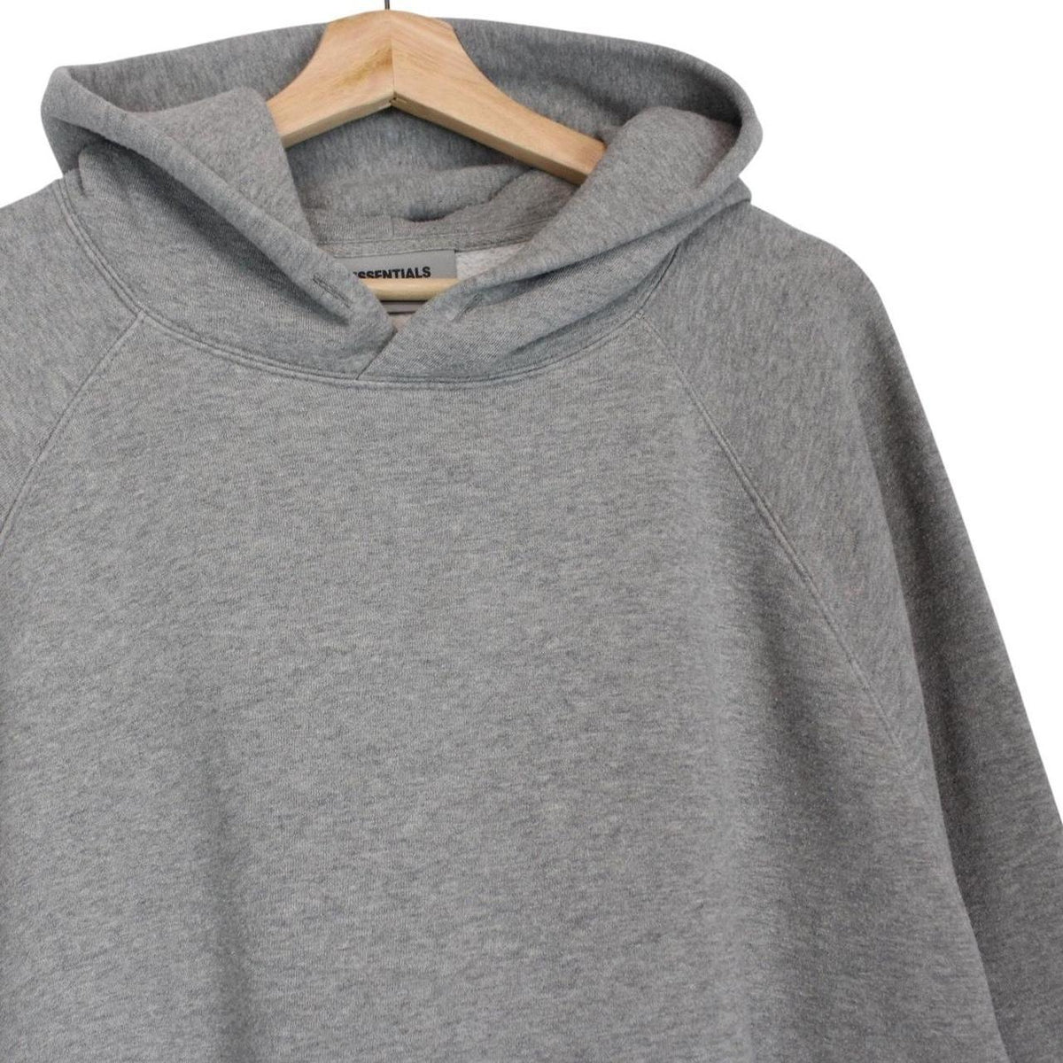 Essentials grey hoodie jumper with oversized fit and subtle logo detail.