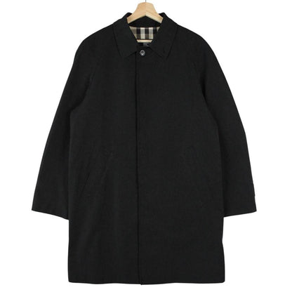 Burberry black Balmacaan coat with Nova Check lining and logo detail.
