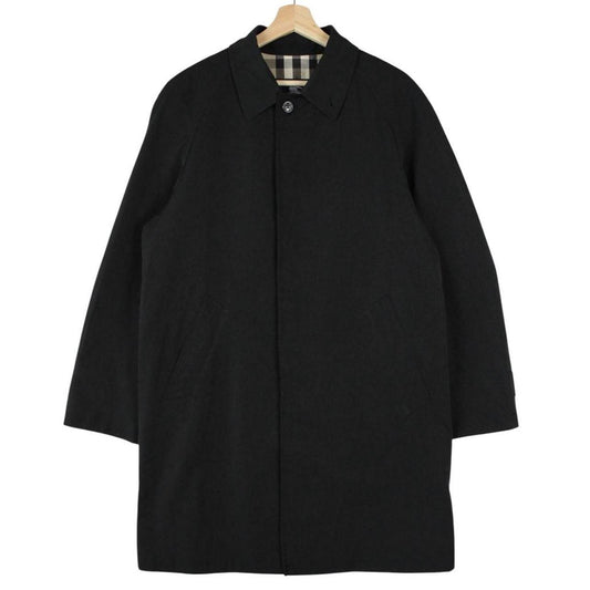 Burberry black Balmacaan coat with Nova Check lining and logo detail.