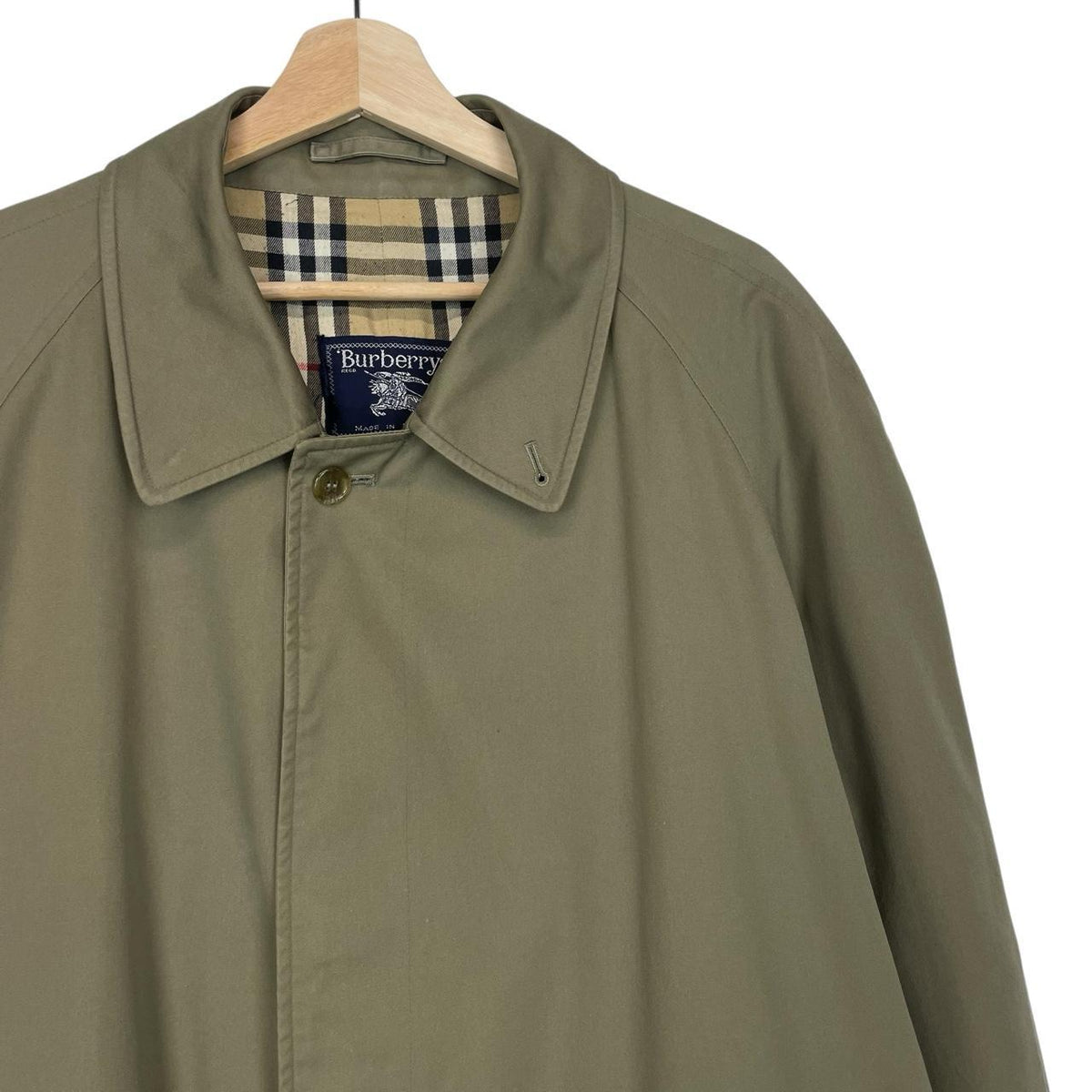 Burberry khaki green trench coat featuring classic Nova Check pattern and single breasted design.