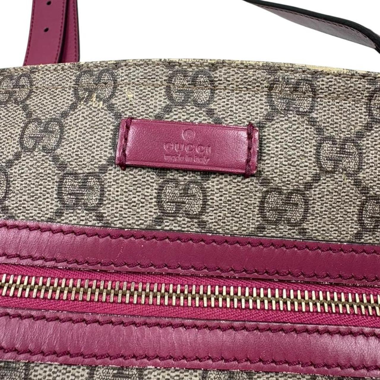 Gucci beige and pink duffel bag with GG Supreme monogram canvas pattern.