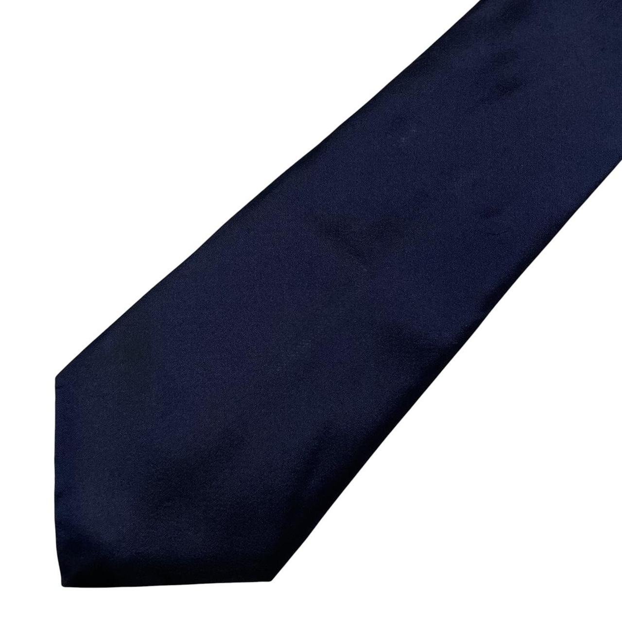 DKNY navy blue silk tie with subtle sheen and classic design.