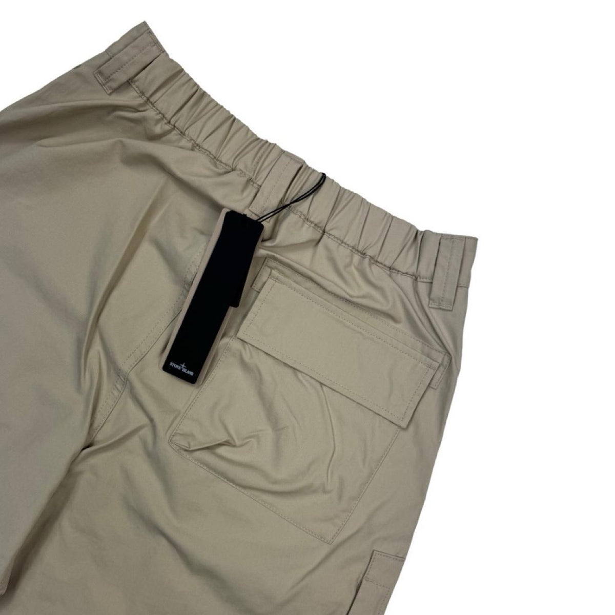 Stone Island beige cargo trousers with logo patch and multiple pockets.