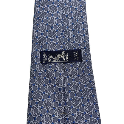 Hermes blue silk tie with geometric print and logo detail.