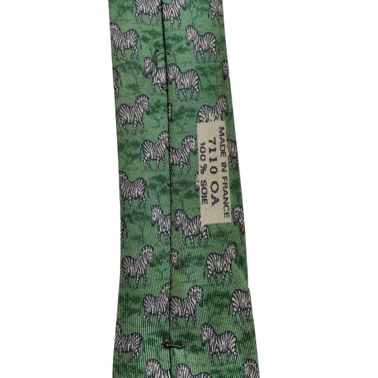 Hermes green silk tie featuring zebra print design and logo detail.