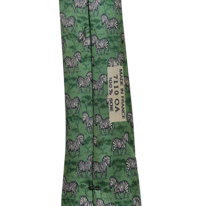 Hermes green silk tie featuring zebra print design and logo detail.