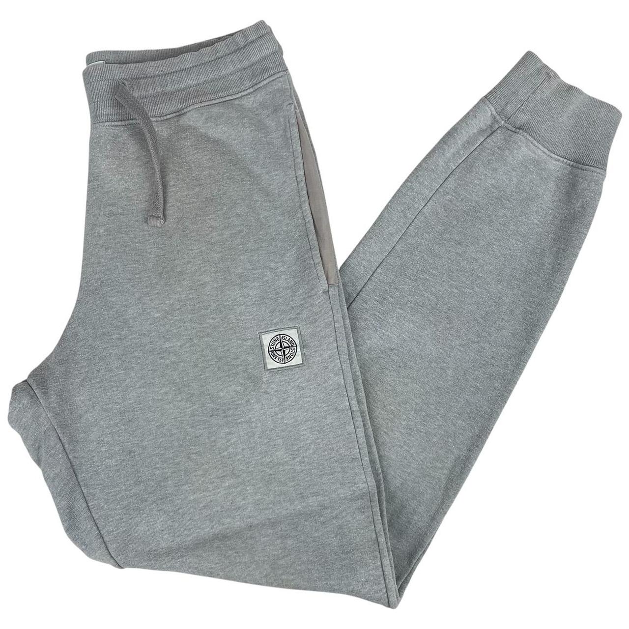 Stone Island grey tracksuit bottoms cotton material with logo patch and faint marks.