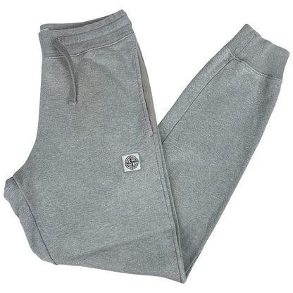 Stone Island grey tracksuit bottoms cotton material with logo patch and faint marks.
