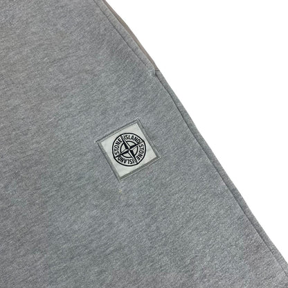 Stone Island grey tracksuit bottoms cotton material with logo patch and faint marks.