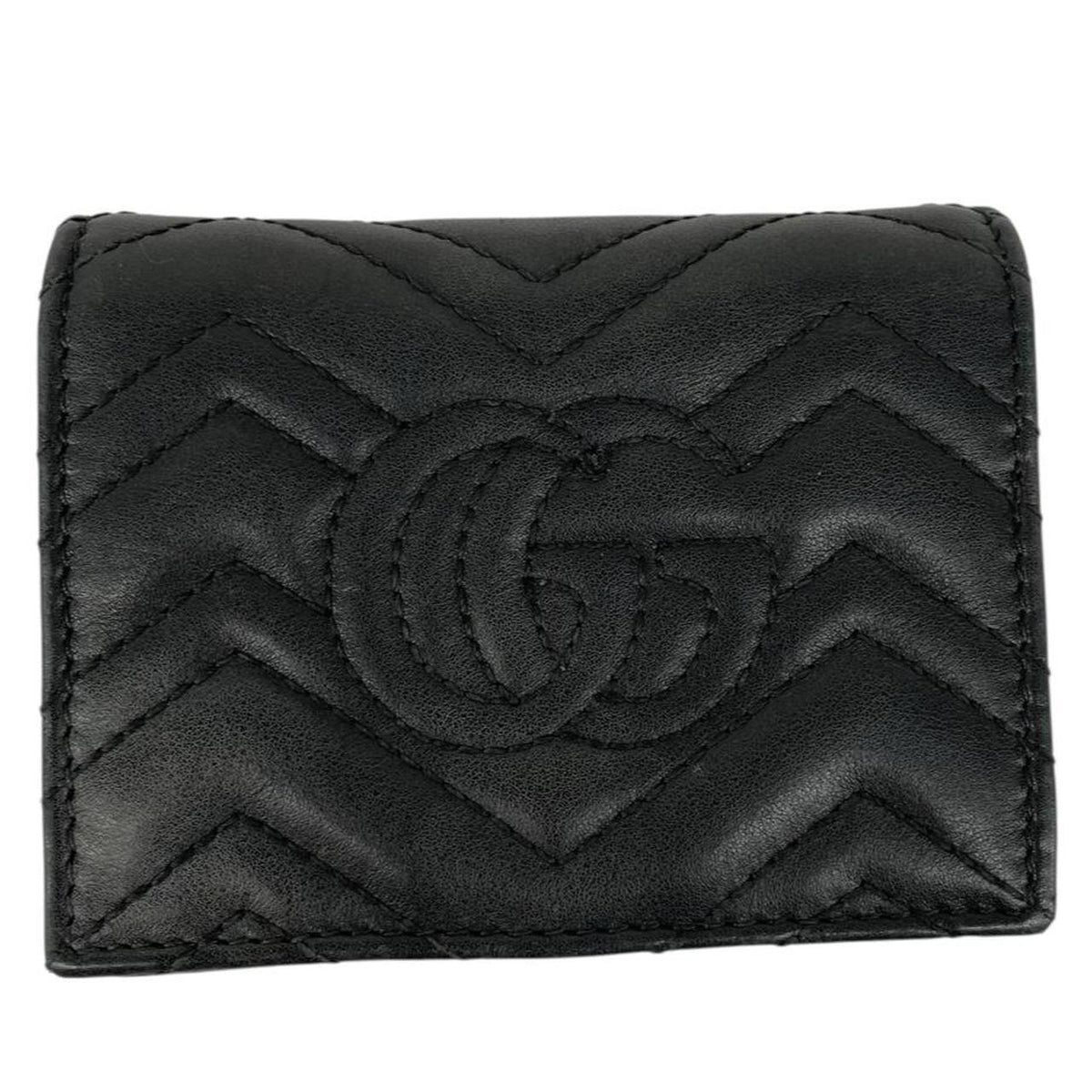Gucci black calfskin wallet with matelassé pattern and GG logo detail.