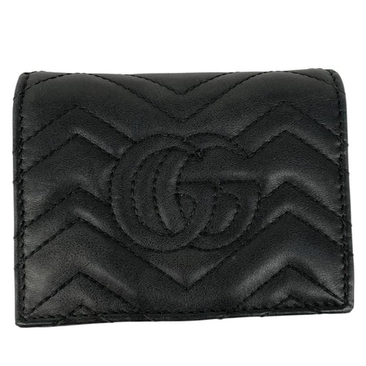 Gucci black calfskin wallet with matelassé pattern and GG logo detail.